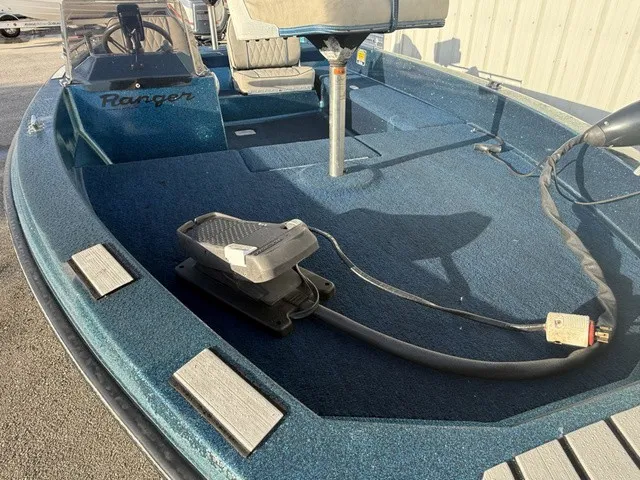 Slide: The Image of A blue 1985 Ranger 330-v with carpeted deck and steering console. - 7