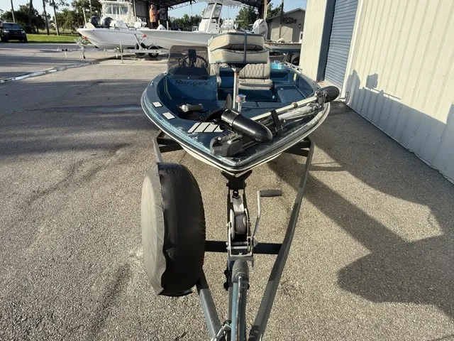 Slide: The Image of A 1985 Ranger 330-v boat is on a trailer in an outdoor area. - 6