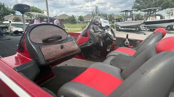 Slide: The Image of The image shows the cockpit of a red 2007 Ranger 519 VX boat with gray and red seats. - 7