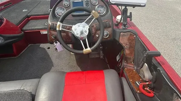 Slide: The Image of The image shows the cockpit of a 2007 Ranger 519 VX boat with a red and black seat. - 14