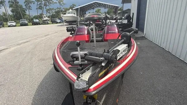 Slide: The Image of A 2007 Ranger 519 VX boat with red and black design, parked on a trailer. - 8