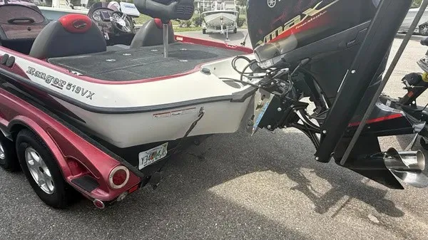 Slide: The Image of A 2007 Ranger 519 VX boat with a red and white hull, mounted on a trailer. - 5