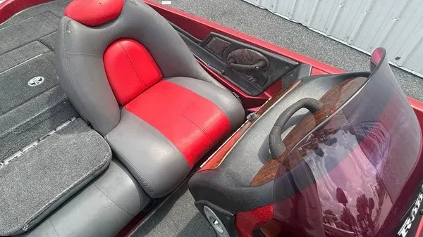 Slide: The Image of The image shows the interior of a 2007 Ranger 519 VX boat with red and gray seats. - 12