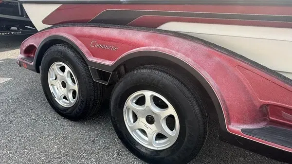 Slide: The Image of Close-up of a boat trailer with red fenders and silver rims. - 2