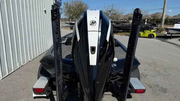 Slide: The Image of The image shows the rear of a black Blazer 625 Pro Elite boat with an engine. - 3