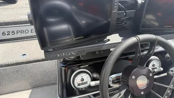 Slide: The Image of The image shows the dashboard of a Blazer 625 Pro Elite boat with Garmin screens. - 12