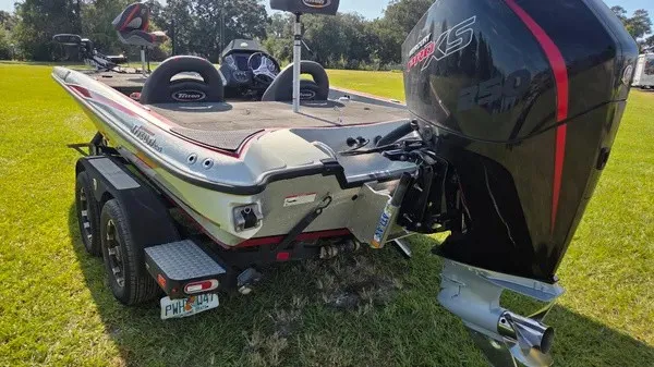 Slide: The Image of A 2021 Triton 20 TrX boat on a trailer, parked on grass. - 9