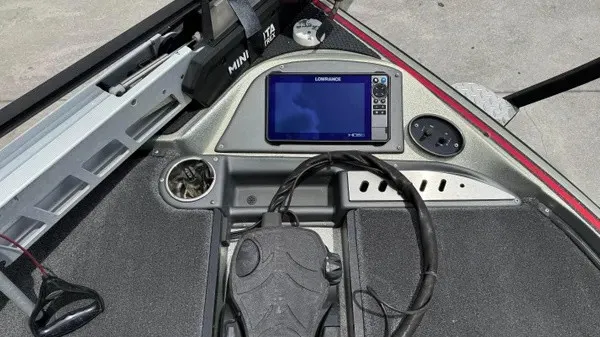 Slide: The Image of The image shows the cockpit of a 2021 Triton 20 TrX boat with a Lowrance fishfinder. - 12