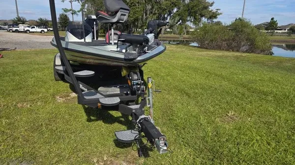 Slide: The Image of A 2021 Triton 20 TrX boat is on a trailer on a grassy area. - 4