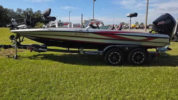 Slide: The Image of A 2021 Triton 20 TrX boat on a trailer, parked on grass. - 7