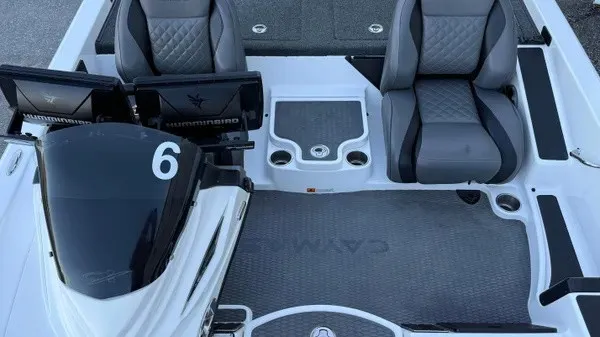 Slide: The Image of The image shows the cockpit of a 2022 Caymas CX 20 PRO boat with gray seats. - 11