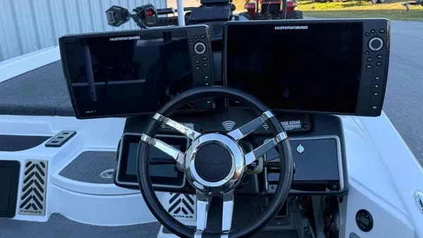 Slide: The Image of The image shows the cockpit of a 2022 Caymas CX 20 PRO boat with modern navigation systems. - 3