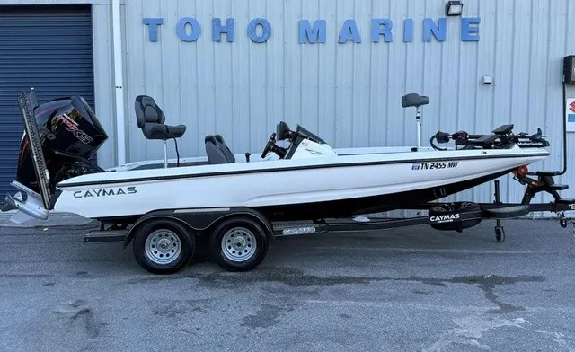 The Image of A white 2022 Caymas CX 20 PRO boat on a trailer in front of a building. - 1