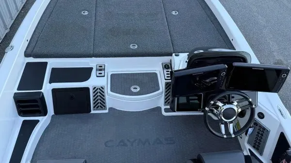 Slide: The Image of The image shows the cockpit of a 2022 Caymas CX 20 PRO boat with modern instruments. - 10