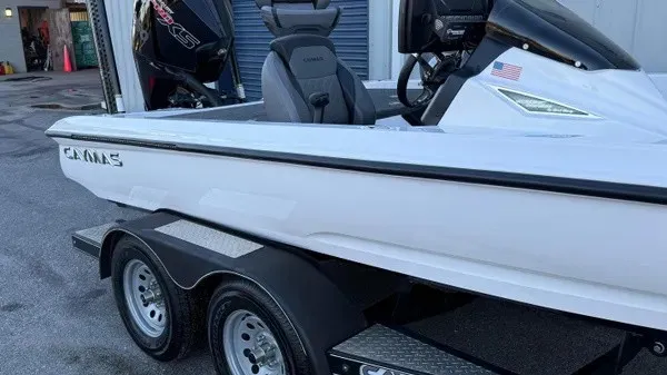 Slide: The Image of A white 2022 Caymas CX 20 PRO boat on a trailer, ready for use. - 2
