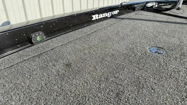 Slide: The Image of Close-up of the deck of a Ranger Z118 Comanche boat with gray carpeting. - 22