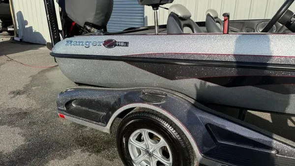 Slide: The Image of A 2015 Ranger Z118 Comanche on a trailer. The boat features a shiny exterior. - 3