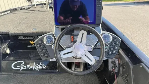 Slide: The Image of The image shows the cockpit of a Ranger Z118 Comanche boat with a modern steering wheel and electronics. - 17