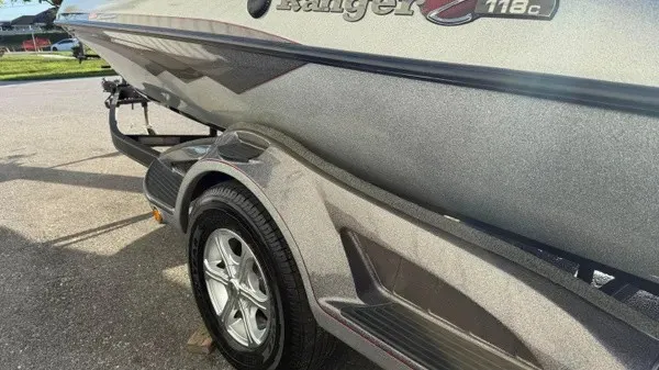 Slide: The Image of A 2015 Ranger Z118 Comanche boat on a trailer, featuring a sleek gray hull. - 8