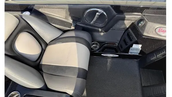Slide: The Image of The image shows the interior of a 2015 Ranger Z118 Comanche with cushioned seats and dashboard. - 15