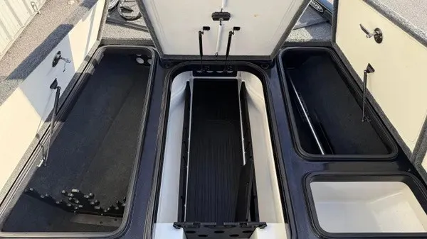 Slide: The Image of The image shows the storage compartments of a 2015 Ranger Z118 Comanche boat. - 13