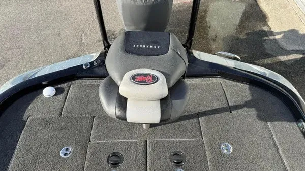 Slide: The Image of The image shows the seating area of a 2015 Ranger Z118 Comanche boat with gray carpeting. - 18