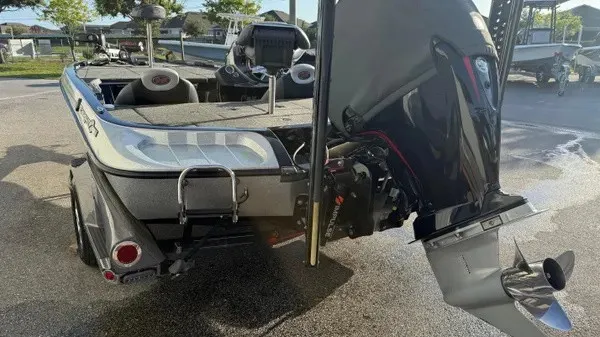 Slide: The Image of A 2015 Ranger Z118 Comanche with a powerful outboard motor, parked on a trailer. - 7