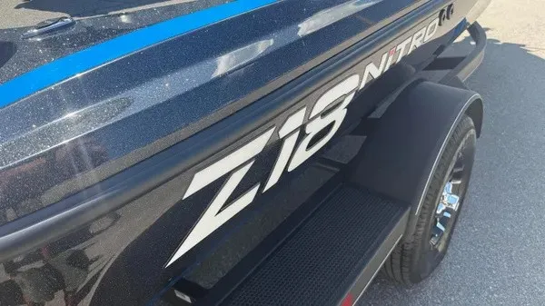 Slide: The Image of Close-up of the 2022 Nitro Z18 boat with a glossy black hull and blue accents. - 3