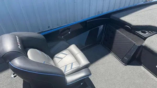Slide: The Image of A gray seat with blue accents in a boat, surrounded by gray carpeting. - 16