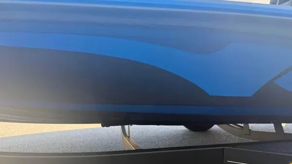 Slide: The Image of Close-up of a blue hull of a 2022 Nitro Z18 boat on a trailer. - 7