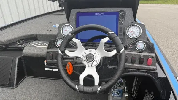 Slide: The Image of The image shows the cockpit of a 2022 Nitro Z18 boat with a modern steering wheel and instruments. - 3