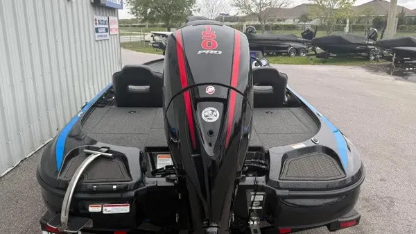 Slide: The Image of A 2022 Nitro Z18 boat with a powerful outboard motor, parked on a paved lot. - 6