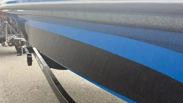 Slide: The Image of A blue and black boat with a sleek hull is on a trailer. - 8