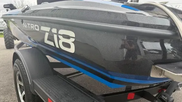 Slide: The Image of A black Nitro Z18 boat from 2022 on a trailer, featuring blue accents and sleek lines. - 7