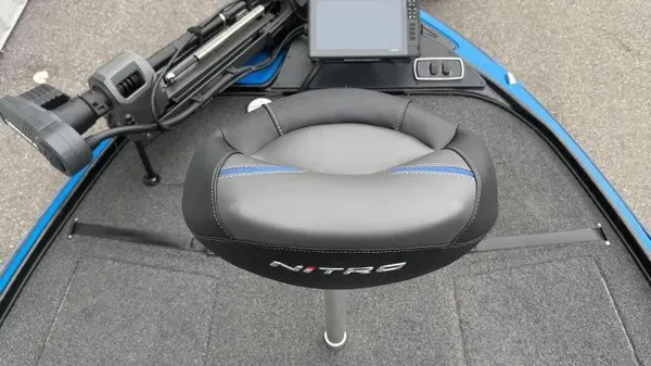 Slide: The Image of A gray and black seat with Nitro logo on a boat, surrounded by gray carpeting. - 12