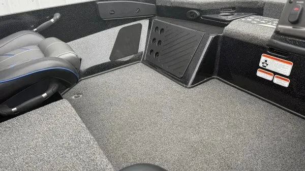 Slide: The Image of Interior of a 2022 Nitro Z18 boat with gray carpet flooring and black seating. - 4