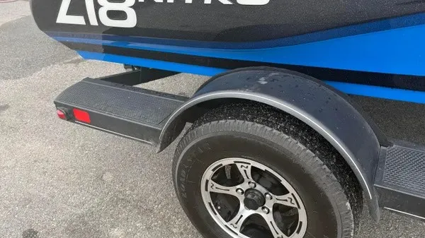 Slide: The Image of Close-up of a boat trailer with a Nitro Z18 boat, 2022 model, in blue and black. - 2