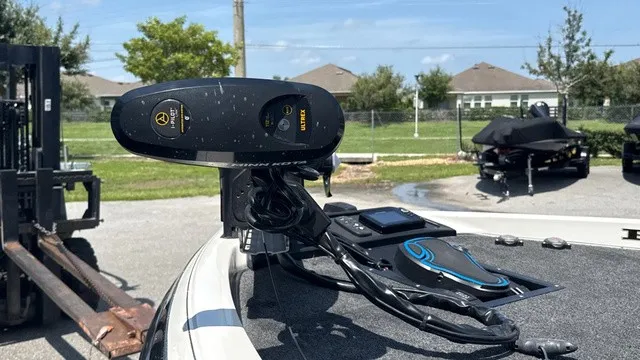 Slide: The Image of A 2005 Ranger 520 VX Comanche with a modern fish finder on the deck, surrounded by other boats. - 7