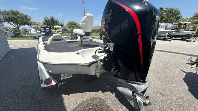 Slide: The Image of A 2005 Ranger 520 VX Comanche with a large outboard motor, parked on a trailer. - 4