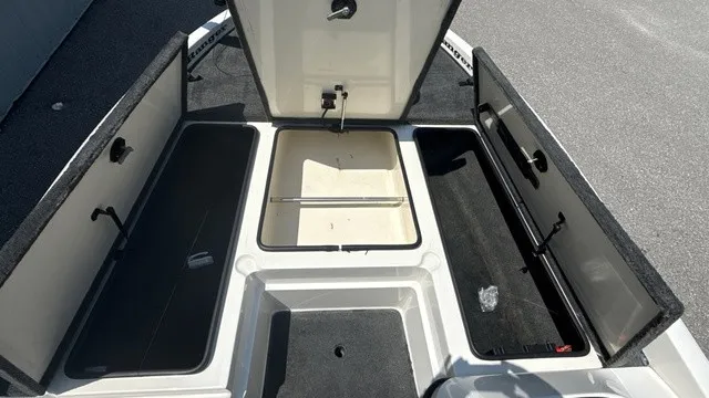 Slide: The Image of The image shows the storage area of a 2005 Ranger 520 VX Comanche boat with open compartments. - 12