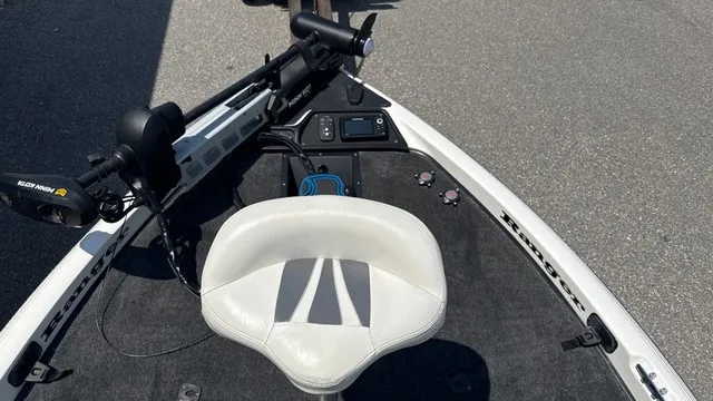 Slide: The Image of A 2005 Ranger 520 VX Comanche with a white seat and control panel on a gray deck. - 10