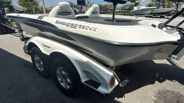 Slide: The Image of A white 2005 Ranger 520 VX Comanche boat on a trailer, ready for transport. - 5