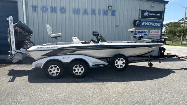 The Image of A white 2005 Ranger 520 VX Comanche boat on a trailer in front of a building. - 1