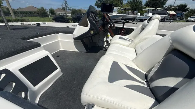Slide: The Image of The image shows the cockpit of a 2005 Ranger 520 VX Comanche with white and gray seats. - 9