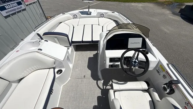 Slide: The Image of The image shows the cockpit of a Stingray 192 SC boat with white seating and a Garmin display. - 14