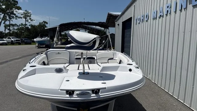 Slide: The Image of A white Stingray 192 SC boat is parked next to a building. - 5