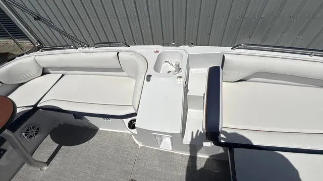 Slide: The Image of The image shows the cockpit of a Stingray 192 SC boat with white upholstery and a small sink. - 7