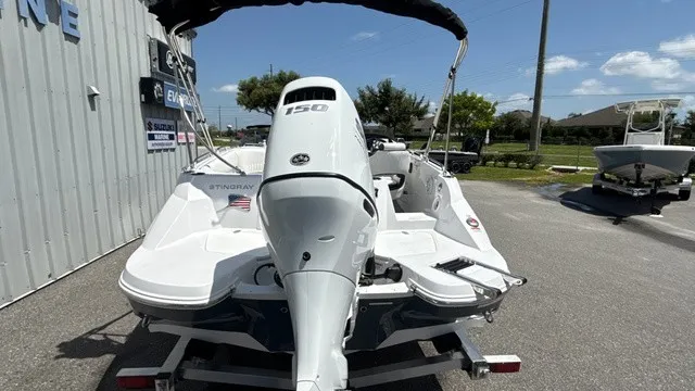 Slide: The Image of A white Stingray 192 SC boat with a 150 HP outboard motor is on a trailer. - 3
