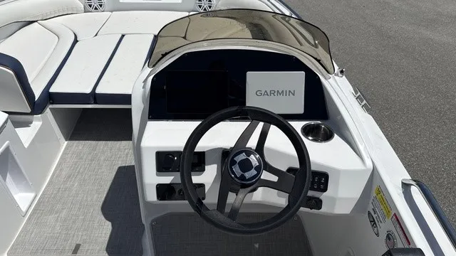 Slide: The Image of The image shows the cockpit of a Stingray 192 SC boat with a Garmin navigation system. - 10