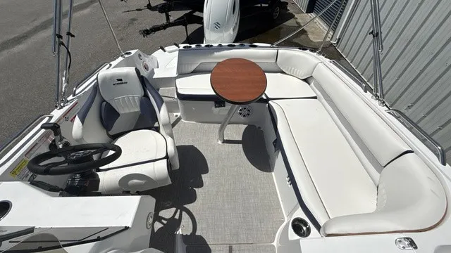 Slide: The Image of The image shows the cockpit of a Stingray 192 SC boat with white seating and a round table. - 9